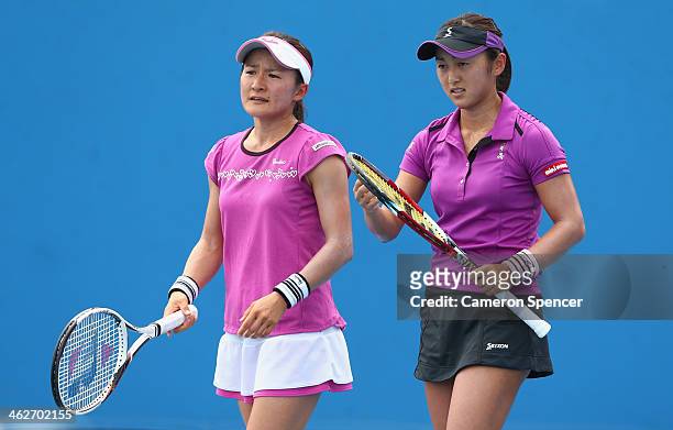 Misaki Doi of Japan and Shuko Aoyama of Japan talk tactics in their first round doubles match against Varvara Lepchenko of the United States Raluca...