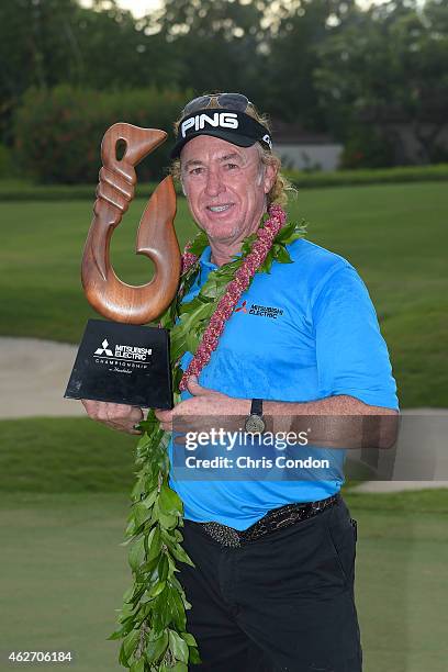 Miguel Angel Jimenez of Spain holds the tournament trophy after winning the Champions Tour Mitsubishi Electric Championship at Hualalai Golf Club on...