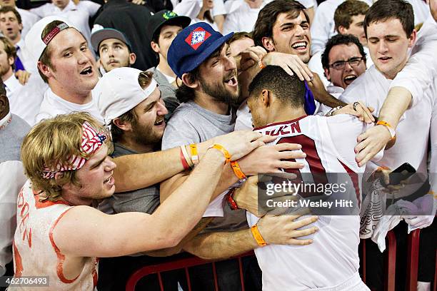 Rashad Madden of the Arkansas Razorbacks celebrates with fans after an overtime win against the Kentucky Wildcats at Bud Walton Arena on January 14,...