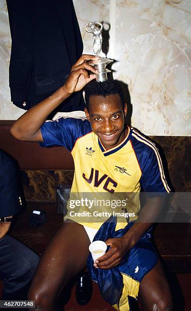 Arsenal goalscorer Michael Thomas celebrates in the dressing room with the Championship trophy lid after his goal sealed a 2-0 victory over rivals...