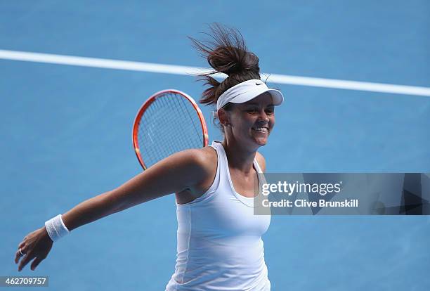 Casey Dellacqua of Australia celebrates winning her second round match against Kirsten Flipkens of Belgium during day three of the 2014 Australian...