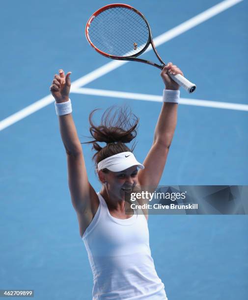 Casey Dellacqua of Australia celebrates winning her second round match against Kirsten Flipkens of Belgium during day three of the 2014 Australian...