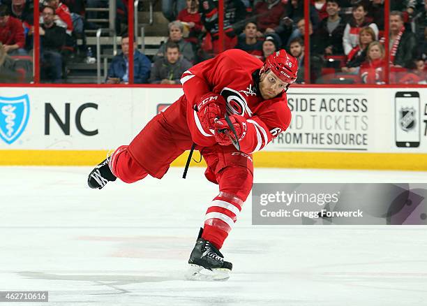 Tim Gleason of the Carolina Hurricanes fires a puck into the offensive zone during their NHL game against the St. Louis Blues at PNC Arena on January...