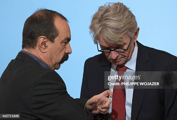 Picture taken on January 19, 2015 shows member of French CGT trade union Philippe Martinez talking to French Force Ouvriere labour union General...