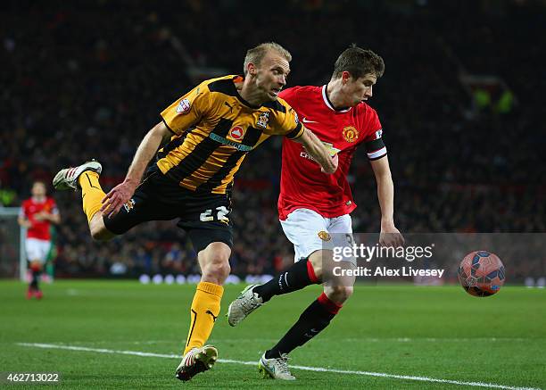 Luke Chadwick of Cambridge United and Paddy McNair of Manchester United battle for the ball during the FA Cup Fourth round replay match between...