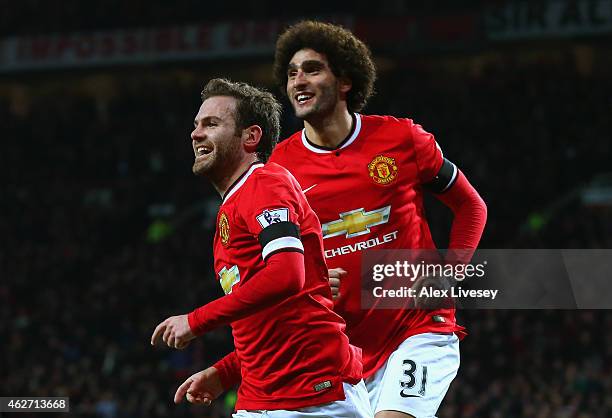 Juan Mata of Manchester United celebrates scoring the opening goal with Marouane Fellaini of Manchester United during the FA Cup Fourth round replay...