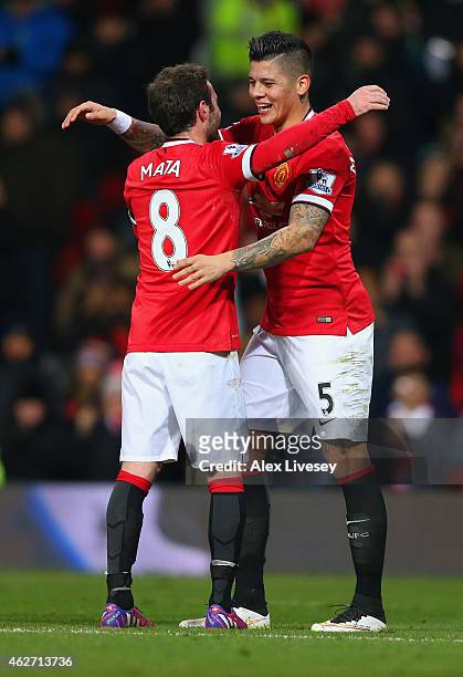Juan Mata of Manchester United congratulates Marcos Rojo of Manchester United on scoring their second goal during the FA Cup Fourth round replay...
