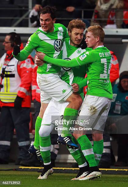 Kevin de Bruyne of Wolfsburg celebrates his team's first goal with team mates Nicklas Bendtner and Marcel Schaefer during the Bundesliga match...