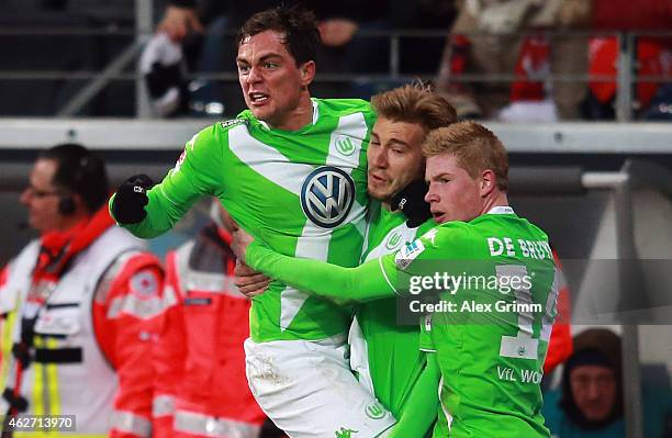 Kevin de Bruyne of Wolfsburg celebrates his team's first goal with team mates Nicklas Bendtner and Marcel Schaefer during the Bundesliga match...