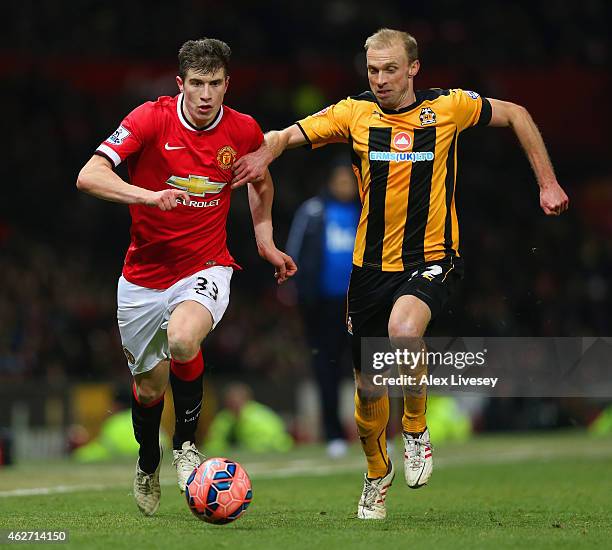 Paddy McNair of Manchester United and Luke Chadwick of Cambridge United battle for the ball during the FA Cup Fourth round replay match between...