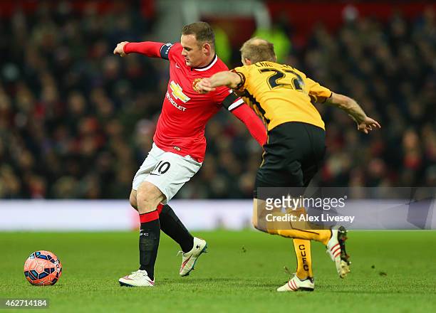 Wayne Rooney of Manchester United is closed down by Luke Chadwick of Cambridge United during the FA Cup Fourth round replay match between Manchester...