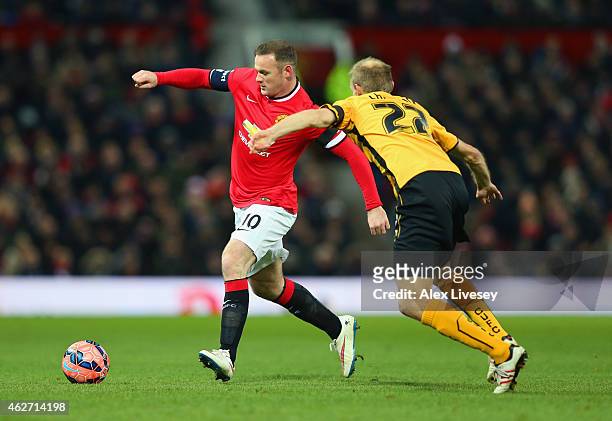 Wayne Rooney of Manchester United is closed down by Luke Chadwick of Cambridge United during the FA Cup Fourth round replay match between Manchester...