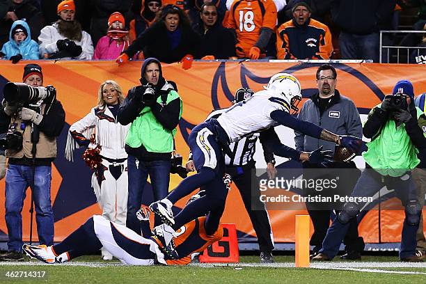 Keenan Allen of the San Diego Chargers scores a fourth quarter touchdown against Michael Huff of the Denver Broncos during the AFC Divisional Playoff...