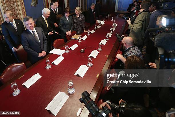 King Abdullah II of Jordan poses for photographs before meeting with members of the Senate Appropriations Committee at the U.S. Capitol February 3,...