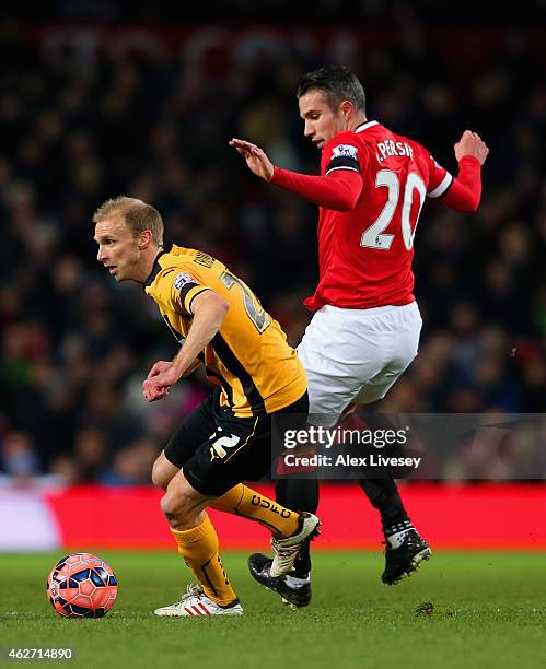 Luke Chadwick of Cambridge United breaks away from Robin van Persie of Manchester United during the FA Cup Fourth round replay match between...