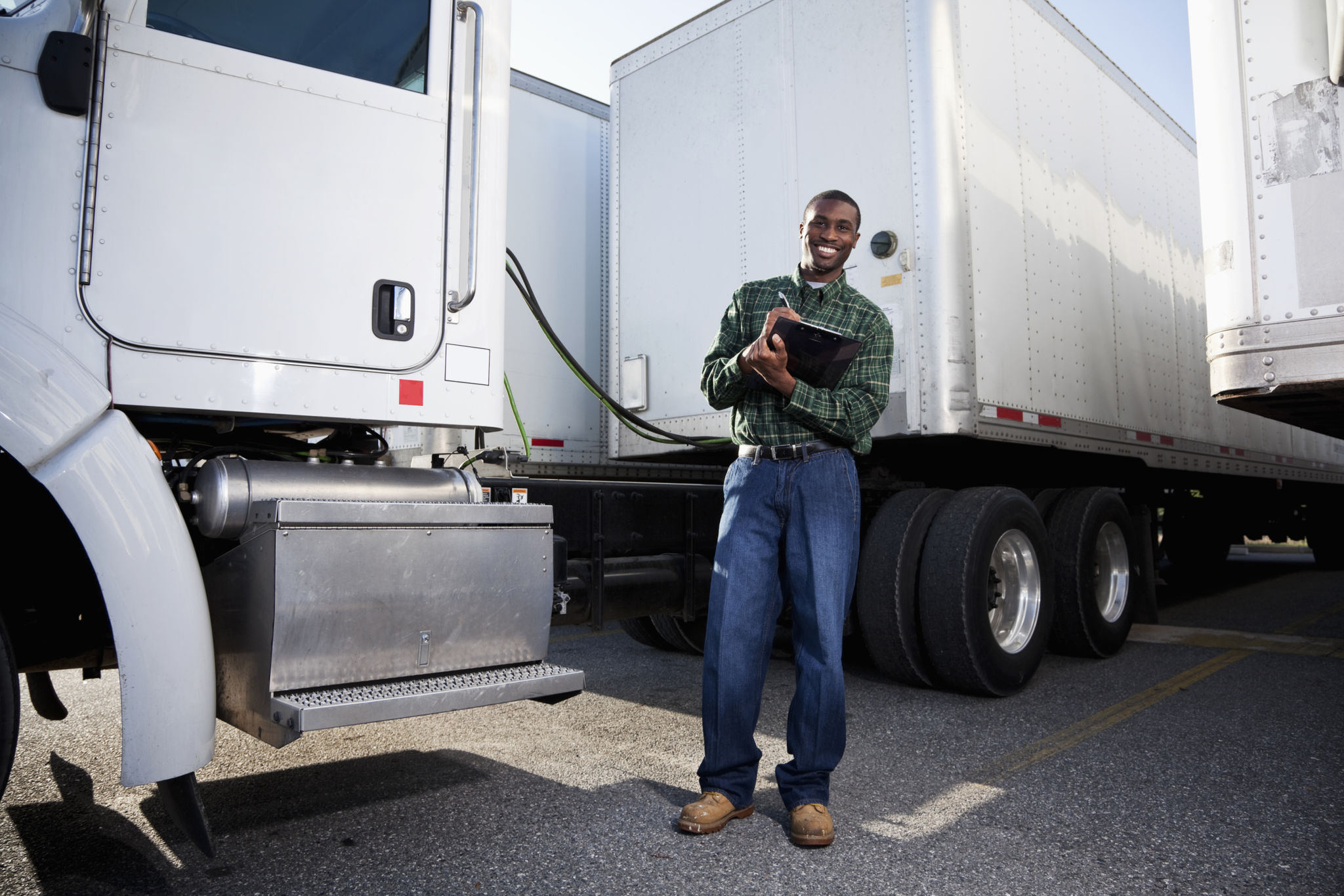 African American truck driver with clipboard African American truck driver with clipboard