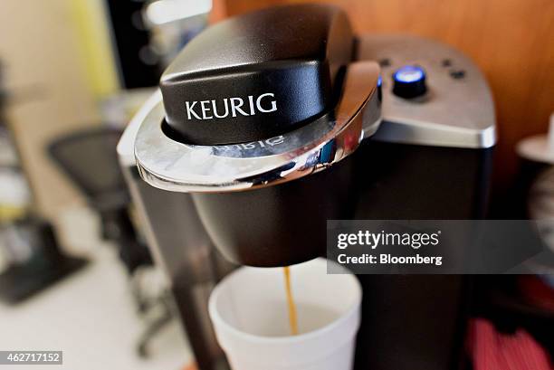 Coffee flows from a Keurig Green Mountain Inc. Machine in this arranged photograph taken at a retail store in Princeton, Illinois, U.S., on Tuesday,...