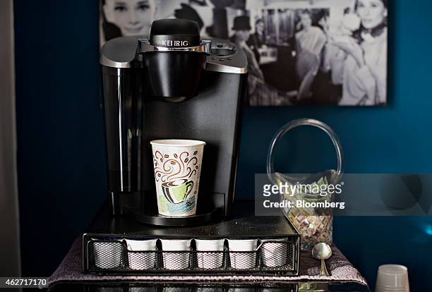 Cup sits in a Keurig Green Mountain Inc. Coffee machine in this arranged photograph taken at a salon in Princeton, Illinois, U.S., on Tuesday, Feb....