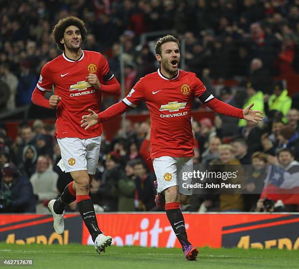 Juan Mata of Manchester United celebrates scoring their first goal during the FA Cup Fourth Round replay between Manchester United and Cambridge...