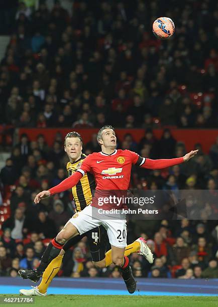 Robin van Persie of Manchester United in action with Josh Coulson of Cambridge United during the FA Cup Fourth Round replay between Manchester United...