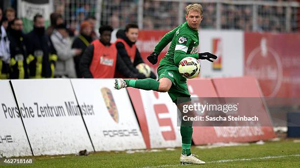 Kevin Schoeneberg of Muenster controls the ball during the 3. Liga match between Preussen Muenster and Dynamo Dresden at Preussenstadion on February...