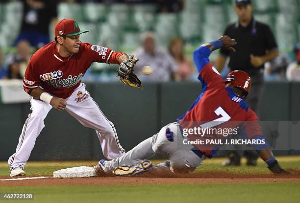 Puerto Rican National baseball team player beats the throw to Mexican National team third baseman Oscar Robles in the second inning of the San Juan...
