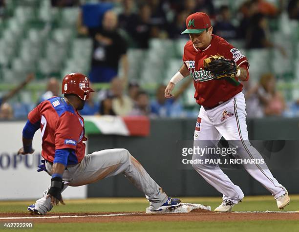 Puerto Rican National baseball team player beats the throw to Mexican National third baseman Oscar Robles in the second inning of the San Juan Serie...