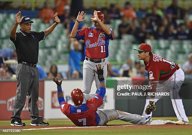 Puerto Rican National baseball team player beats the throw to Mexican National third baseman Oscar Robles before umpire Domingo Polanco and the...