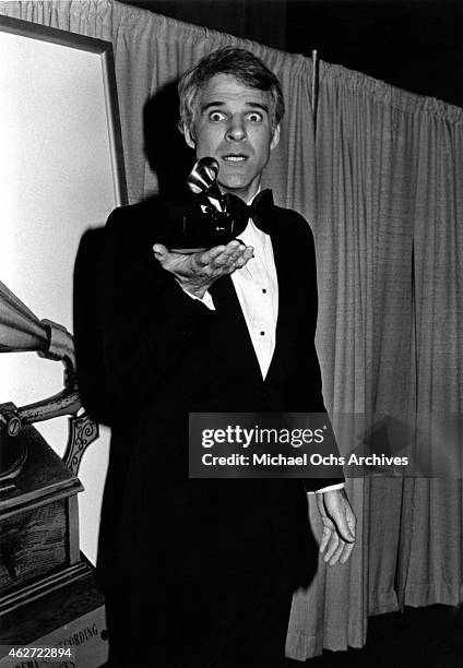 Comedian Steve Martin holds up the Grammy that he won for his album "Let's Get Small" at the Shrine Auditorium on February 23, 1978 in Los Angeles,...