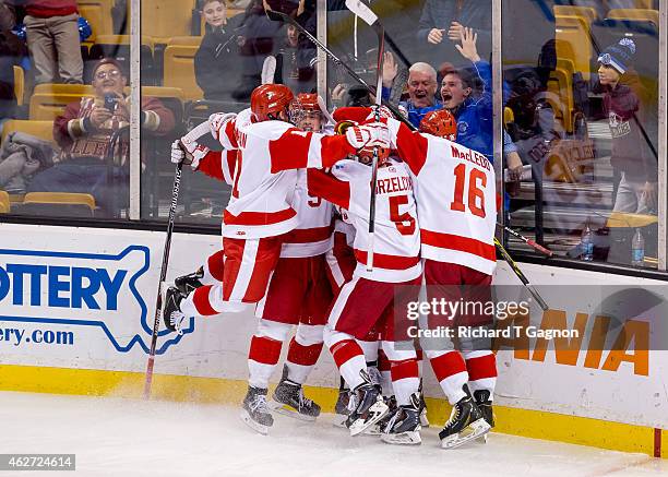 Danny O'Regan of the Boston University Terriers celebrates his double overtime goal with teammates Jack Eichel, Evan Rodrigues, Matt Grzelcyk and...