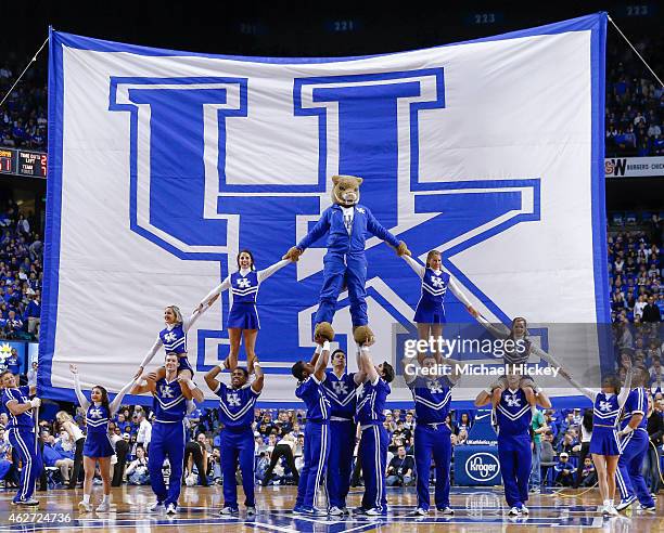 Members of the Kentucky Wildcats cheerleading team pose in front of the University of Kentucky flag during the game against the Alabama Crimson Tide...