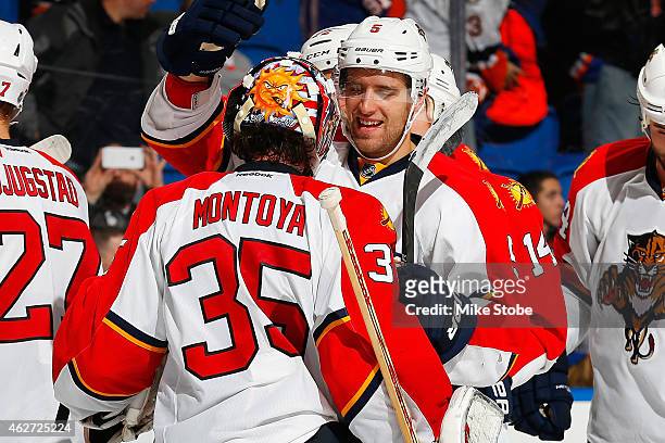 Al Montoya of the Florida Panthers is congratulated by teammate Aaron Ekblad after defeating the New York Islanders at Nassau Veterans Memorial...
