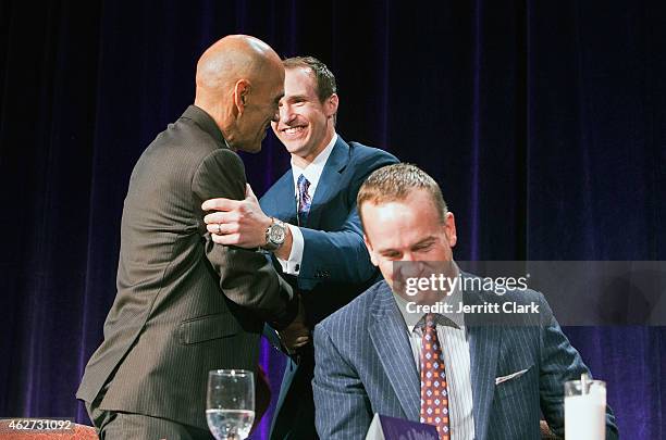Tony Dungee, Drew Brees and Peyton Manning attend the SuperBowl Breakfast where Peyton received the Bart Starr award at JW Marriott Desert Ridge...