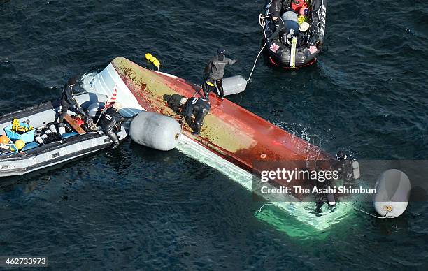 In this aerial image, Japan Coast Guard member investigates the cause of the collision with Japan Maritime Self-Defense Force vessel 'Osumi' around...