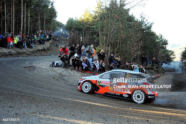 Belgian's driver Thierry Neuville steers his Hyundai i20 on January 15, 2014 in Chateauvieux, southeastern France, during the shakedown of the...