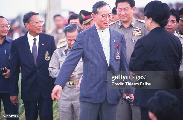 The king of Thailand, Bhumibol Adulyadej, and queen Sirikit , preside over a traditional rice planting ceremony in Ayutthaya.