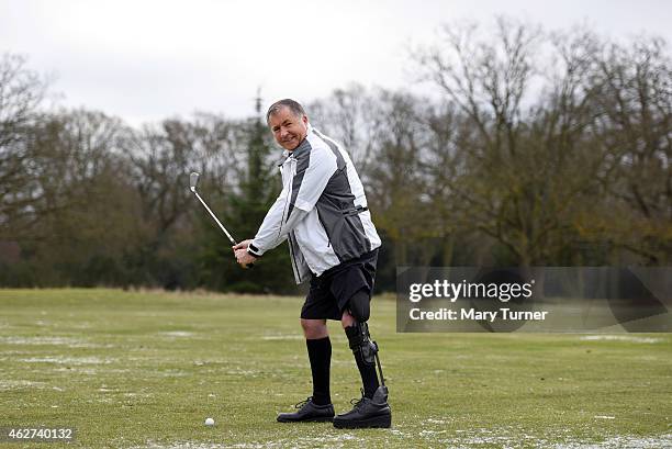 John Simpson takes a golf swing as he displays the C-Brace lower limb bionic exo-skeleton that has allowed him to walk naturally for the first time...