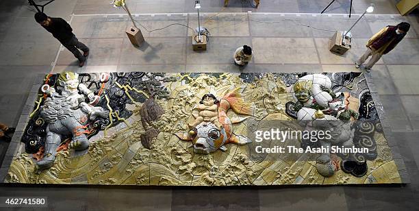 Wall relief designed by Katsuhiko Otomo is viewed by visitors on February 3, 2015 in Atami, Shizuoka, Japan. The work, which measures 8.7 by 2.8...