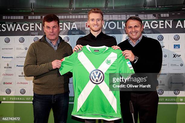 Head coach Dieter Hecking , Andre Schuerrle and Manager Klaus Allofs of Wolfsburg poses for the media during the Press Conference at Volkswagen Arena...