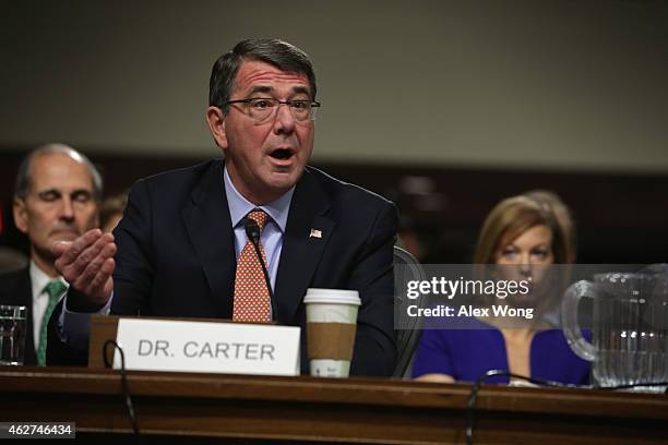 Former U.S. Deputy Secretary of Defense Ashton Carter testifies as his wife Stephanie looks on during his confirmation hearing before the Senate...