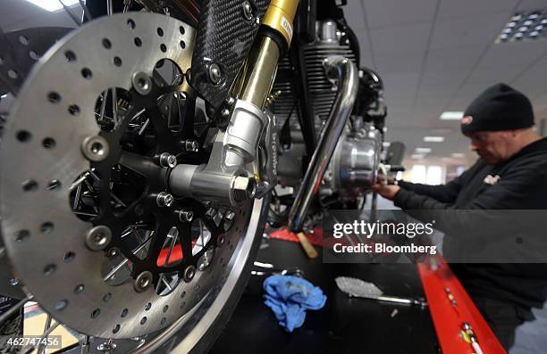 An employee works on a Norton Commando 961 Cafe Racer motorbike, produced by Norton Motorcycles Ltd., during production at the company's assembly...