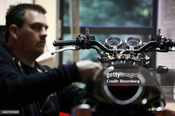 An employee works on a Norton Commando 961 motorbike, produced by Norton Motorcycles Ltd., during production at the company's assembly plant in...