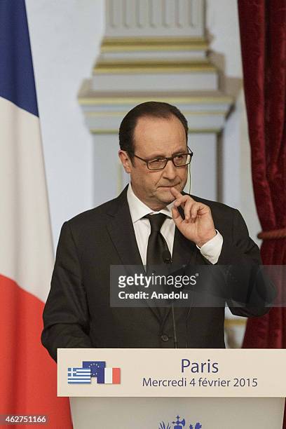 French president Francois Hollande holds a press conference after meeting Greece's Prime Minister Alexis Tsipras at the Elysee presidential palace,...