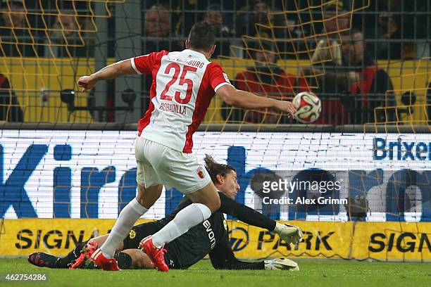 Raul Bobadilla of Augsburg scores the opening goal against Roman Weidenfeller, keeper of Dortmund during the Bundesliga match between Borussia...