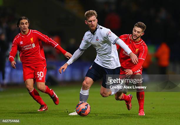 Tim Ream of Bolton Wanderers is marshalled by Adam Lallana of Liverpool during the FA Cup Fourth round replay between Bolton Wanderers and Liverpool...