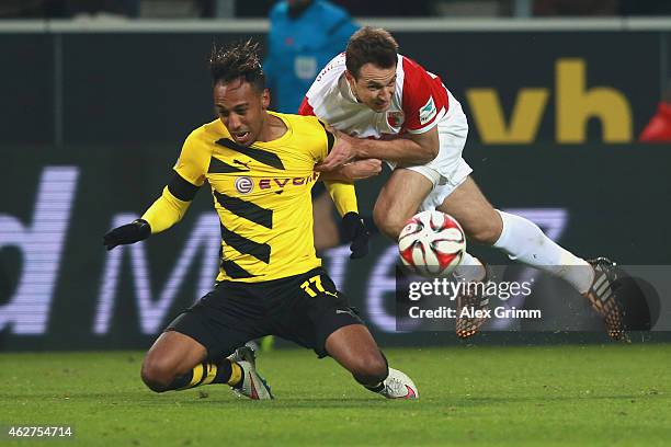Pierre-Emerick Aubameyang of Dortmund battles for the ball with Christoph Janckern of Augsburg during the Bundesliga match between Borussia Dortmund...