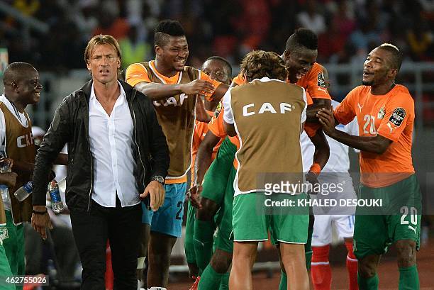 Ivory Coast's players and coach Herve Renard celebrate after scoring a third goal during the 2015 African Cup of Nations semi-final football match...