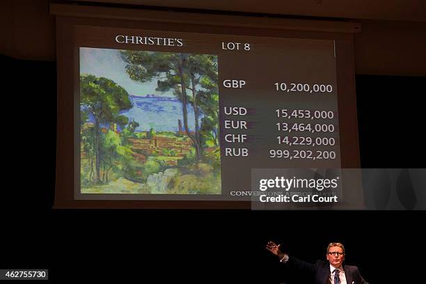 Auctioneer Jussi Pylkkanen takes bids for Vue sur L'Estaque et le Chateau d'If by Paul Cezanne at Christies on February 04, 2015 in London, England....