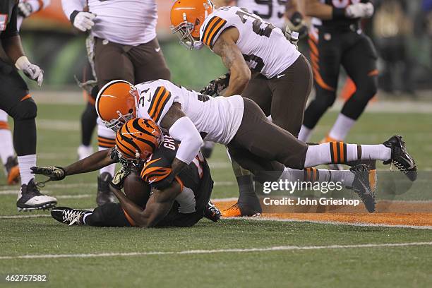 Donte Whitner of the Cleveland Browns tackles A.J. Green of the Cincinnati Bengals during their game at Paul Brown Stadium on November 6, 2014 in...