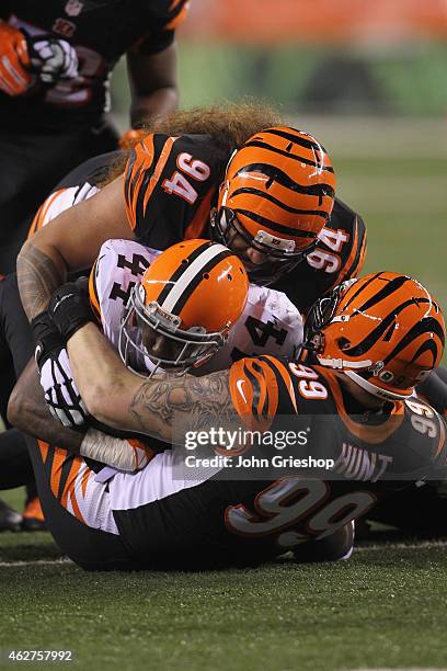 Margus Hunt and Domata Peko of the Cincinnati Bengals make the tackle on Ben Tate of the Cleveland Browns during their game at Paul Brown Stadium on...